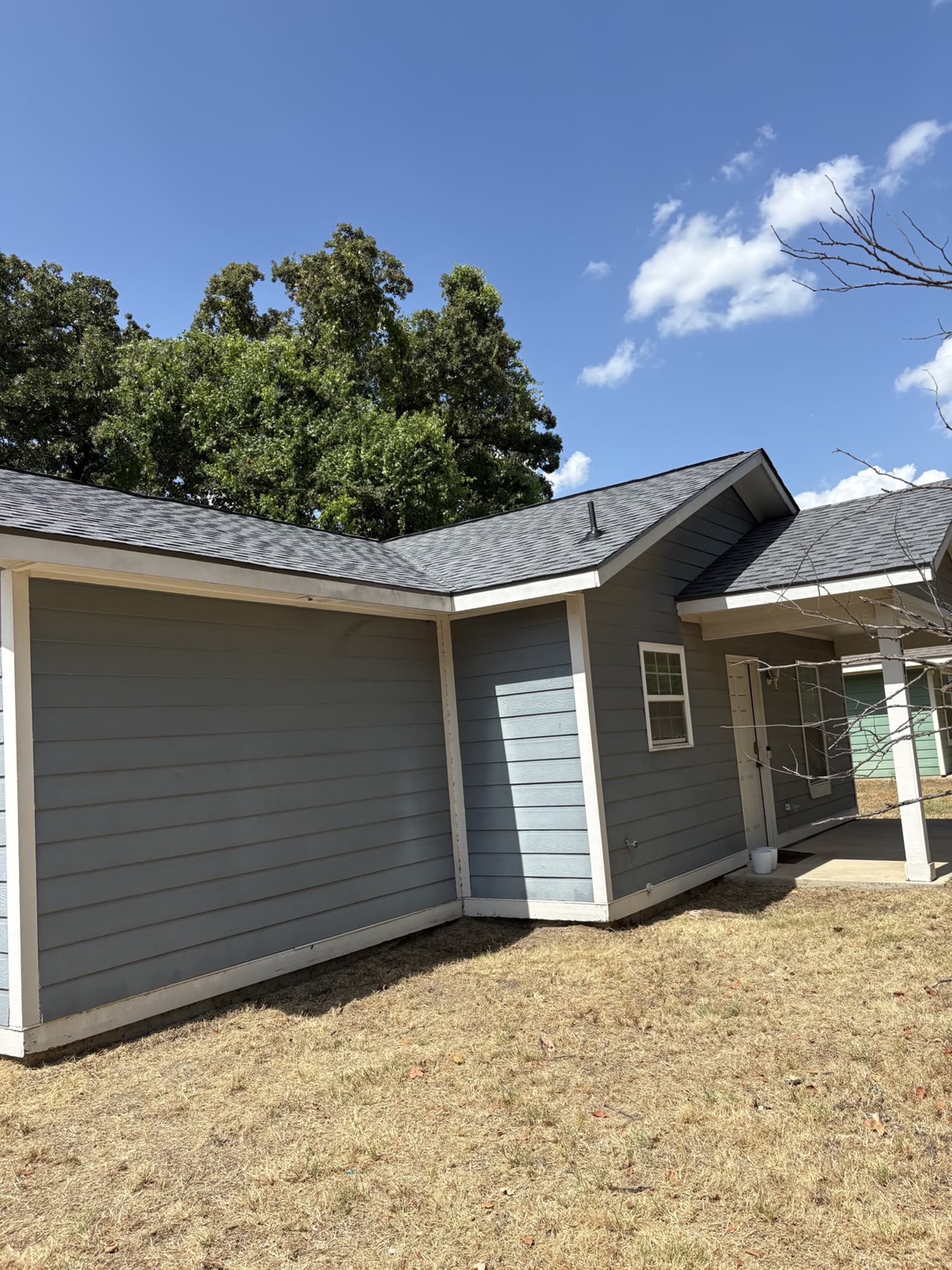 Finished shingle roof on a Dallas home — exterior view of the completed replacement