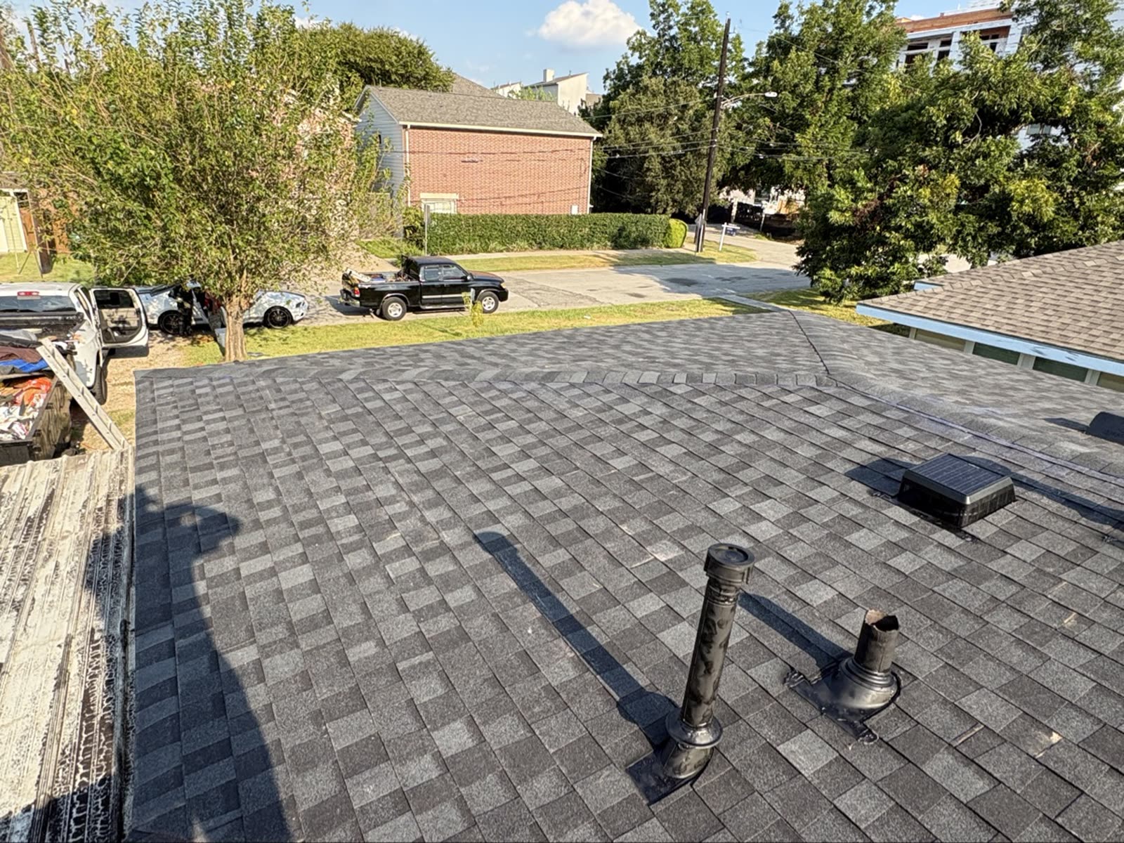 Finished shingle roof on a Houston home with new pipe boots and a solar attic vent